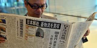 Japanese man reading newspaper