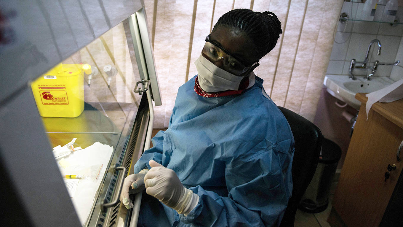 A person sits next to an experimental vaccine against the AIDS