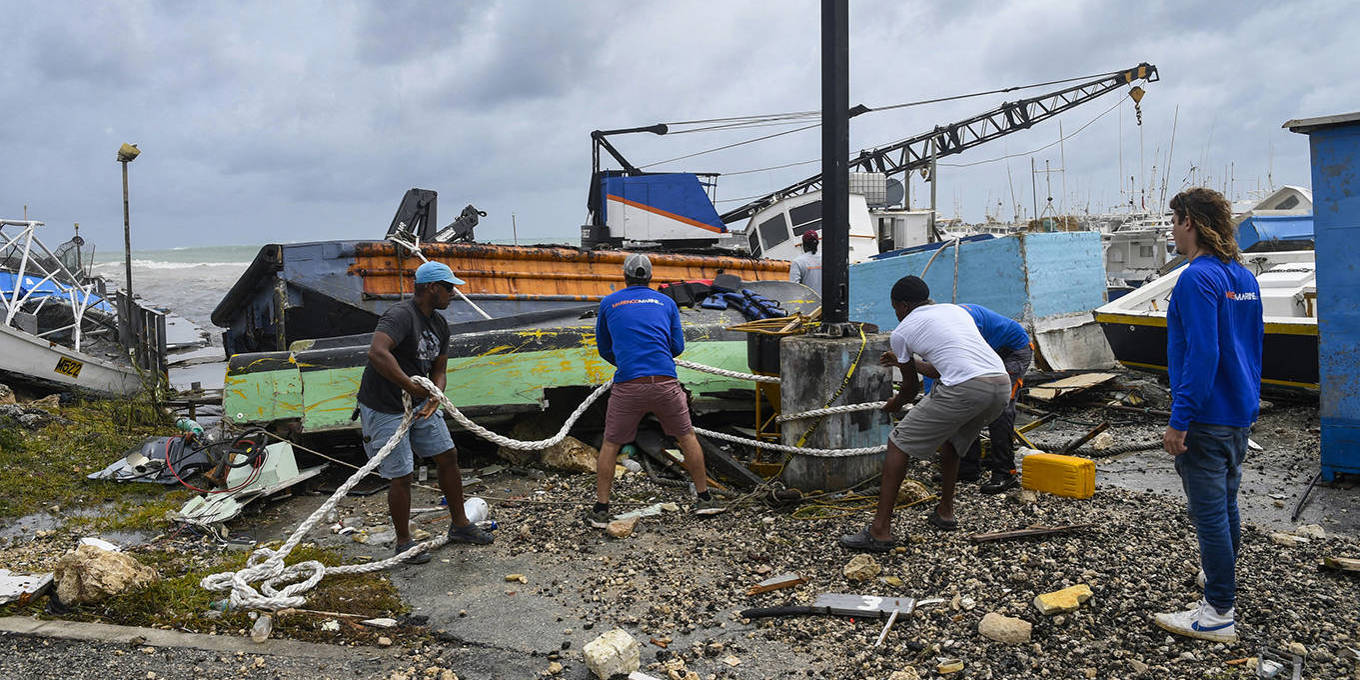 Fisherman cleaning in the harbor after a hurricane in Barbados