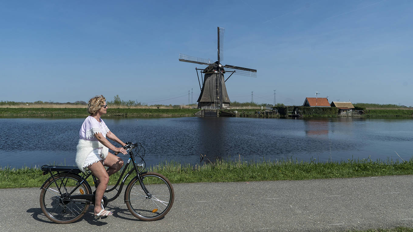 lomborg175_Nicolas EconomouNurPhoto via Getty Images_netherlandswindmillriverbike