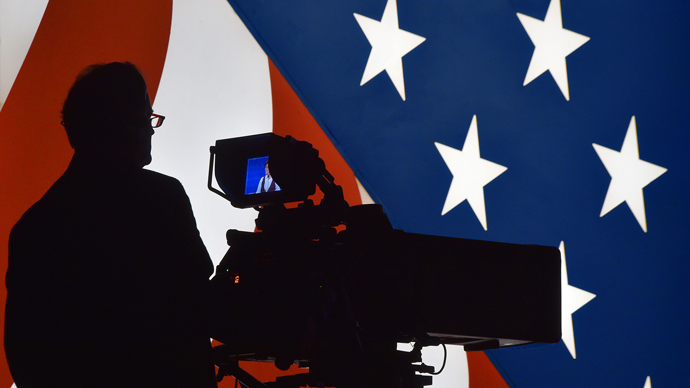 A television cameraman tests his equipment