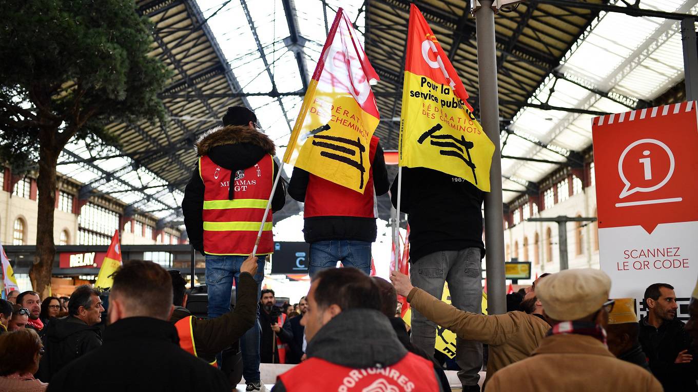 Workers take part in a rally at the Saint-Charles train station