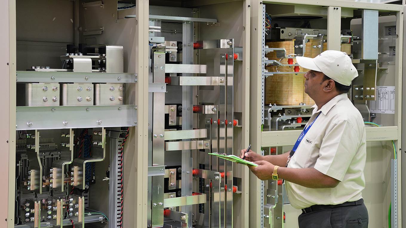 An Indian worker conducts checks in the assembly area of the power electronics factory