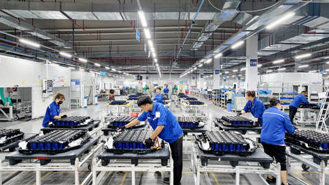 Workers assemble new-energy vehicle batteries on a production line in a Chinese factory.