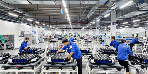 Workers assemble new-energy vehicle batteries on a production line in a Chinese factory.