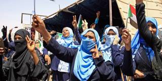 bangura1_ASHRAFSHAZLYAFPGettyImages_sudanesewomenprotestflag