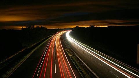 Road and car headlights at night.