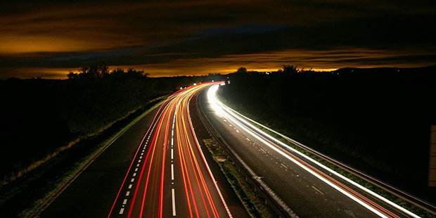 Road and car headlights at night.