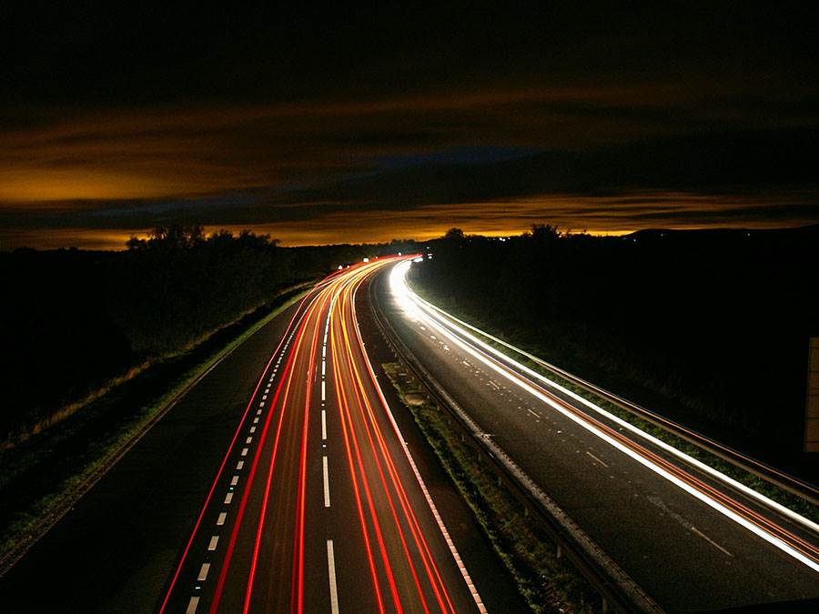 Road and car headlights at night.