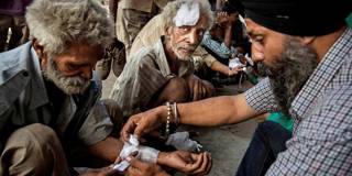  Indian laborers get free medical attention at a street clinic run by a local NGO