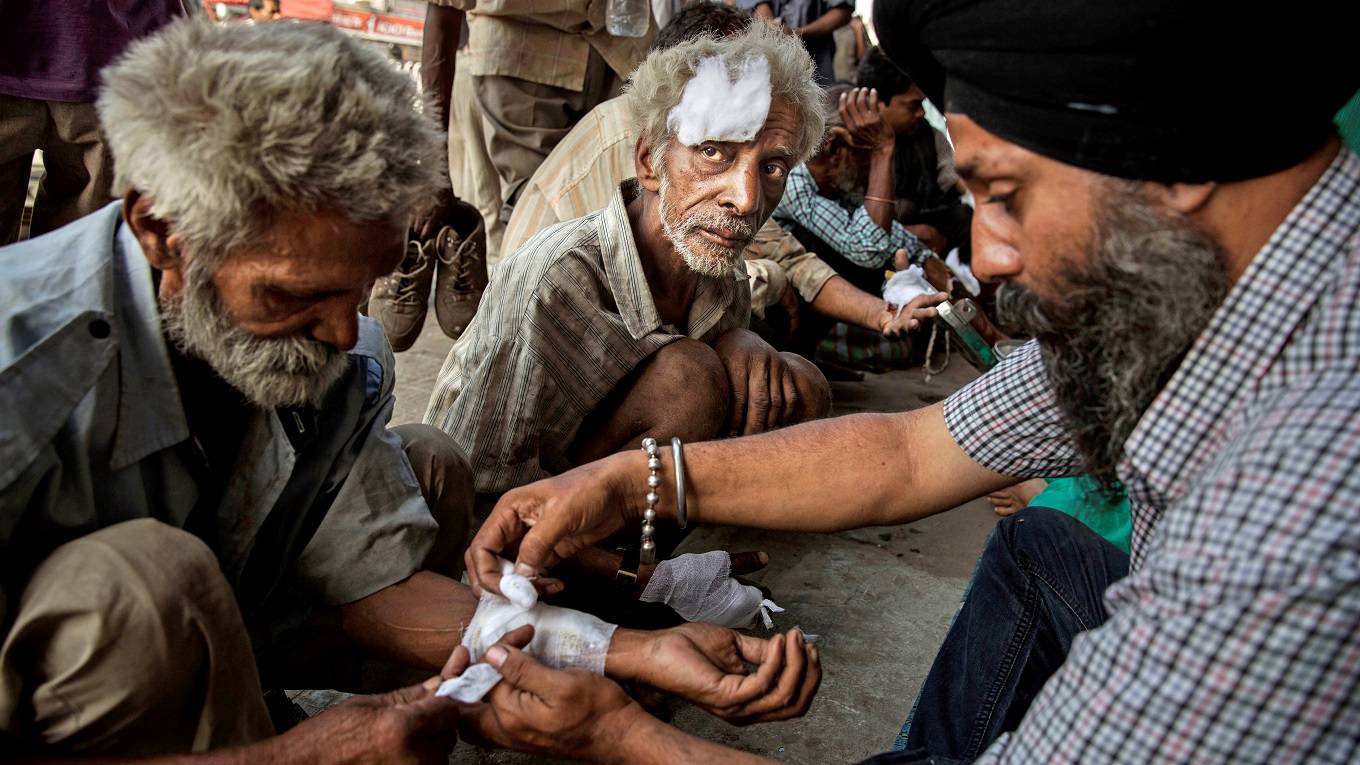 Indian laborers get free medical attention at a street clinic run by a local NGO