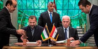 Fatah's Azzam al-Ahmad and Saleh al-Aruri of Hamas sign a reconciliation deal 