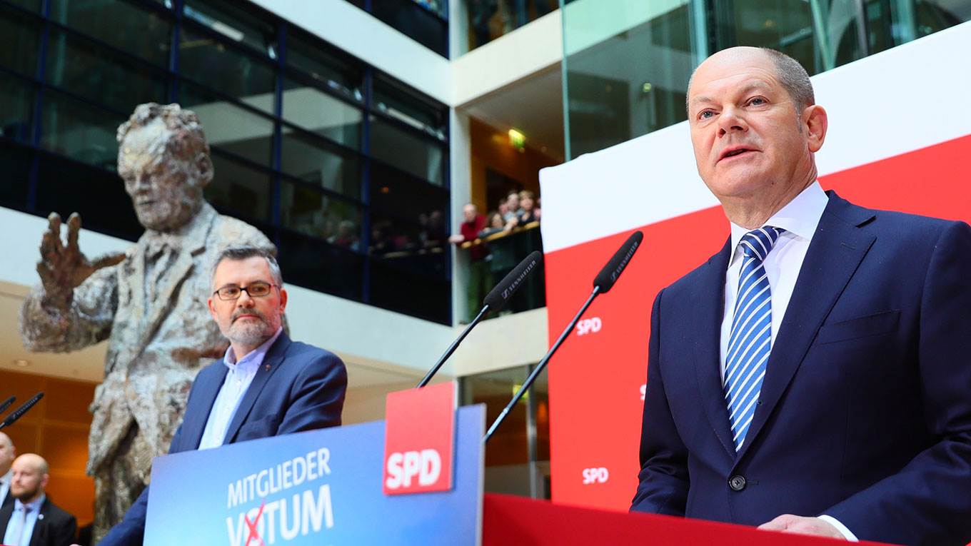 Olaf Scholz, leader of Germany's SPD party, speaks after the members of his party approved a plan to join Angela Merkel's coalition