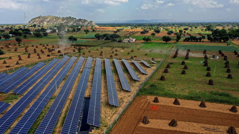 Solar panels at a farm in Bhaloji village, Rajasthan, India, installed by farmer and doctor Amit Singh, illustrating India’s push toward renewable energy ahead of COP26.