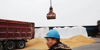 A worker looks on as they load imported soybeans at a port in Nantong in China's eastern Jiangsu province