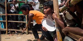 Rohingya Muslim refugees run to receive food