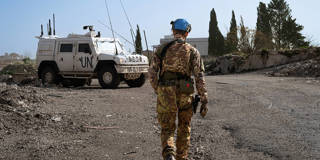 UN peacekeepers stand beside an armored vehicle during a patrol in southern Lebanon.
