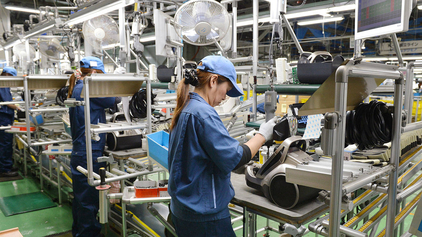 Workers assemble new vacuum cleaners