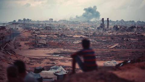 Child looking out on a destroyed Gaza.