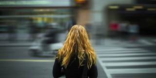 Young girl in out-of-focus urban environment
