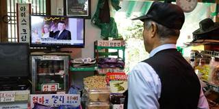 A South Korean watches news the North Korean missile launch at the their store
