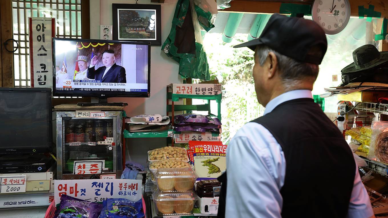 A South Korean watches news the North Korean missile launch at the their store