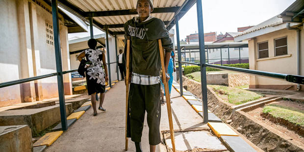 A man walks on crutches at Mulago hospital in Kampala