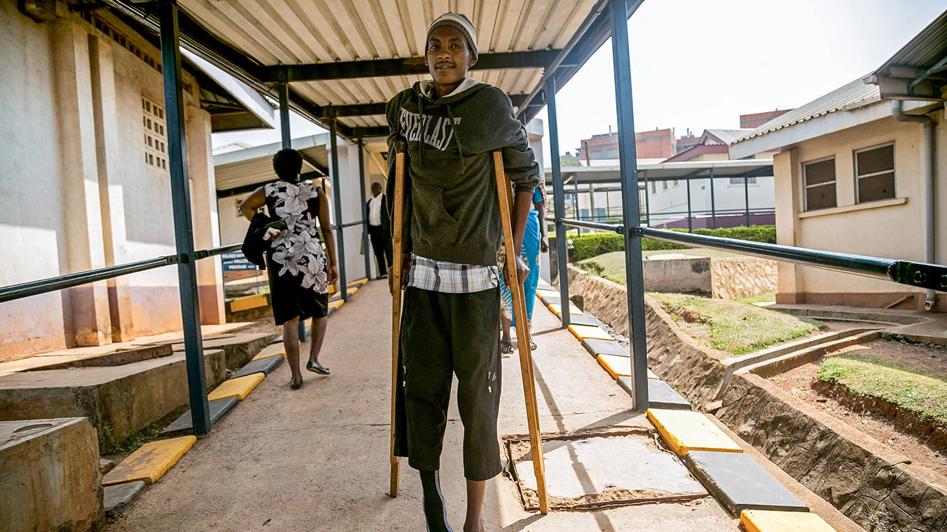 A man walks on crutches at Mulago hospital in Kampala