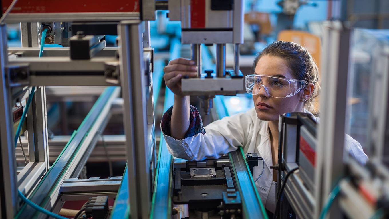 tyson83_skynesherGettyImages_womaninspectingtechmachinery
