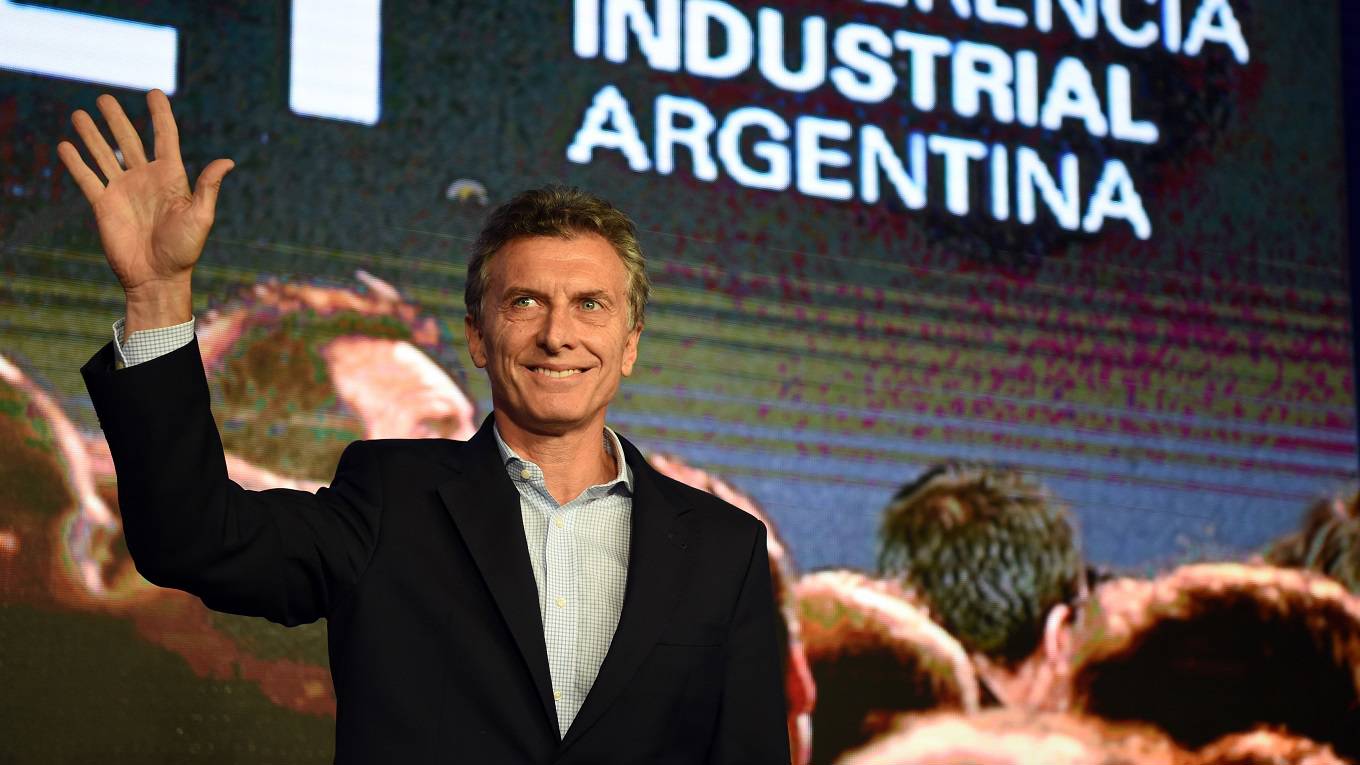 Argentinian President Mauricio Macri waves as he arrives for the closing of a conference organized by the Argentine Industrial Union
