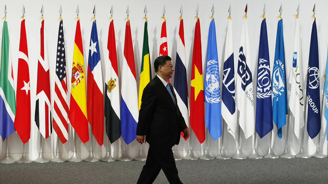woetzel11_KimKyung-Hoon-PoolGettyImages_jinpingwalkinginternationalflags
