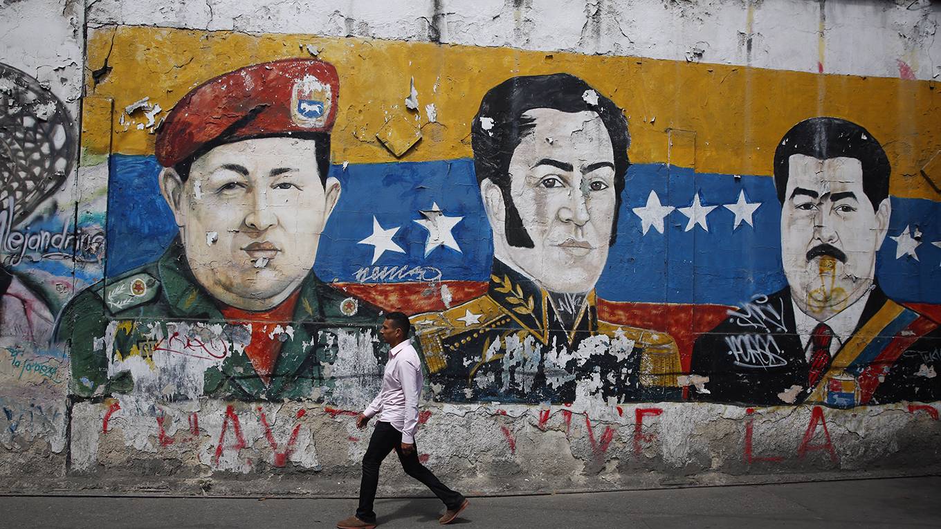 hausmann74_MarcoBelloGettyImages_manwalksvenezuelaleadermural