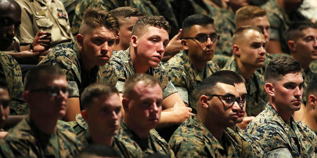 Members of U.S. military listen to Donald Trump