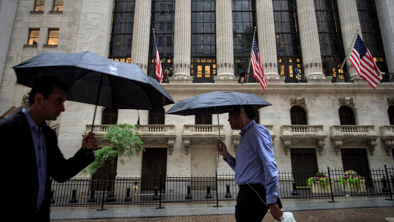 People walk past the New York Stock Exchange