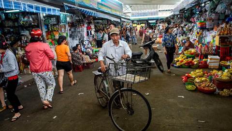 A man walks with his bicycle in the Con Market in the central Vietnamese city of Danang