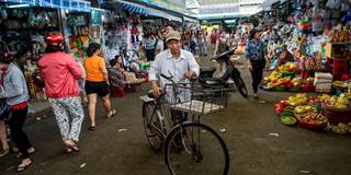 A man walks with his bicycle in the Con Market in the central Vietnamese city of Danang