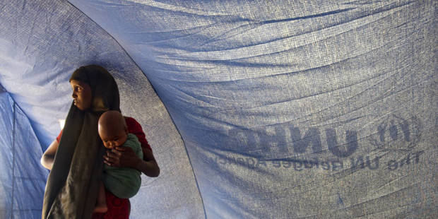 African mother with child in United Nations tent.