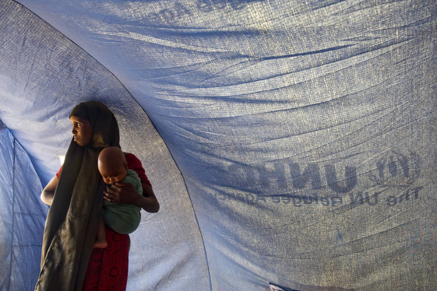 African mother with child in United Nations tent.