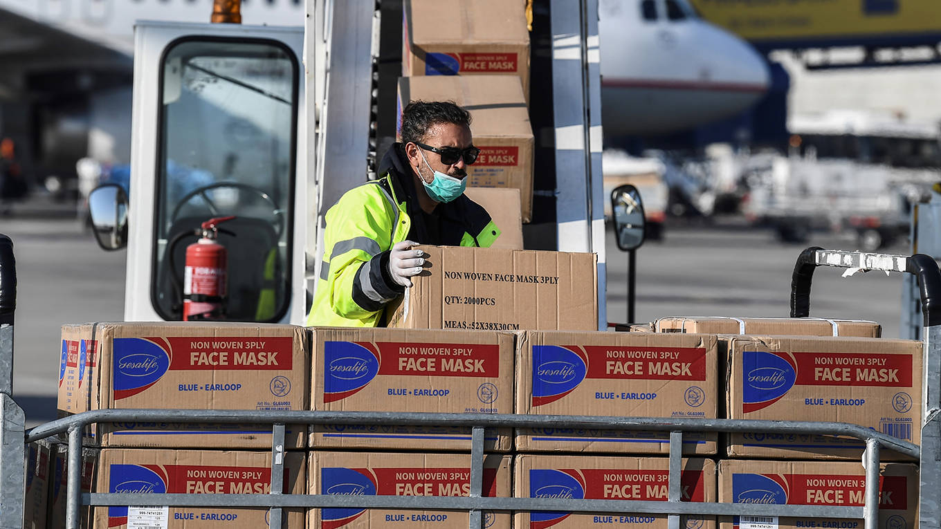ying1_ARIS MESSINISAFP via Getty Images_airportcoronavirussuppliesaidfacemasks
