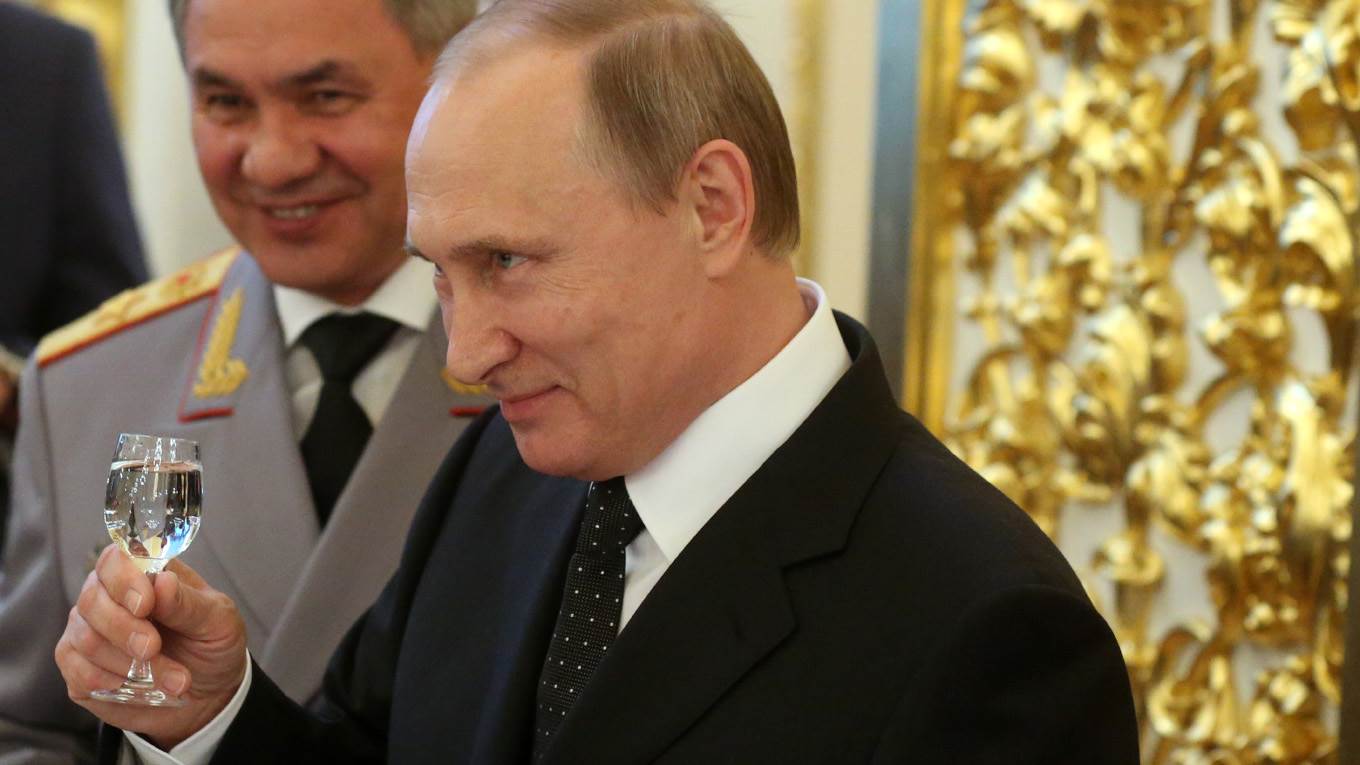 Vladimir Putin toasts glass of vodka_Mikhail Svetlov_Getty Images cropped