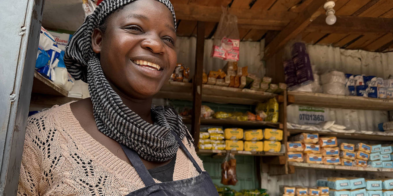 Mary Abongo, a shop owner in Nairobi, Kenya, stands inside her store