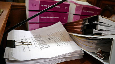 Legislation and regulation books are stacked 