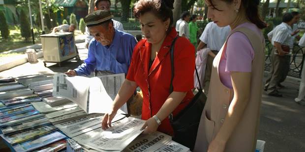 Uzbeks look at the daily sampling of newspapers