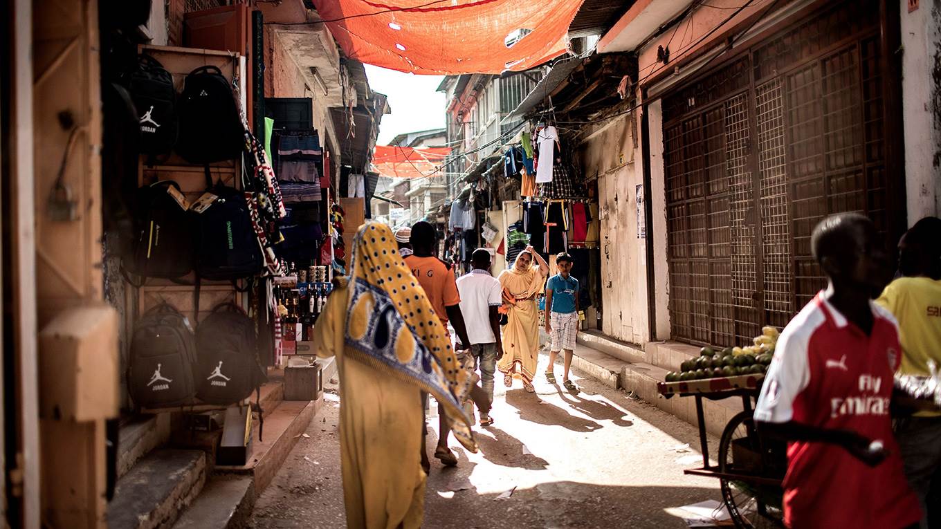 People walk through the alleyways at the Darajani Market