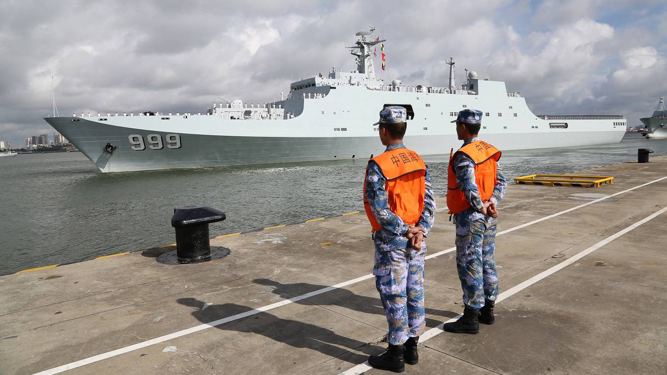 Ships carrying Chinese military personnel depart at a port