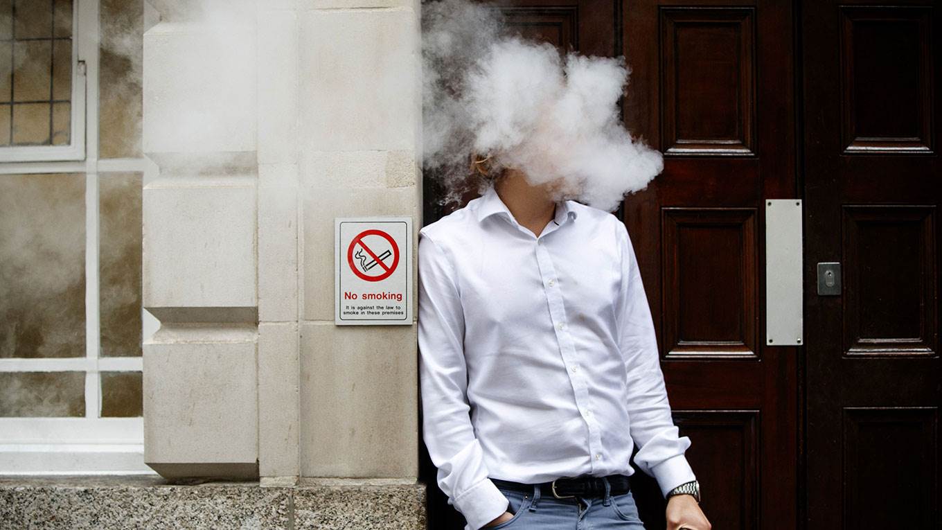 A smoker is engulfed by vapours