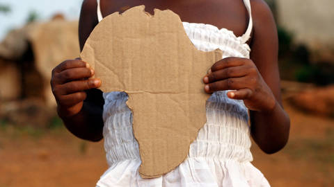 Girl with a cut-out of Africa