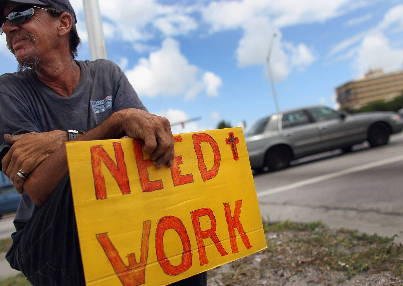 Man with need work sign