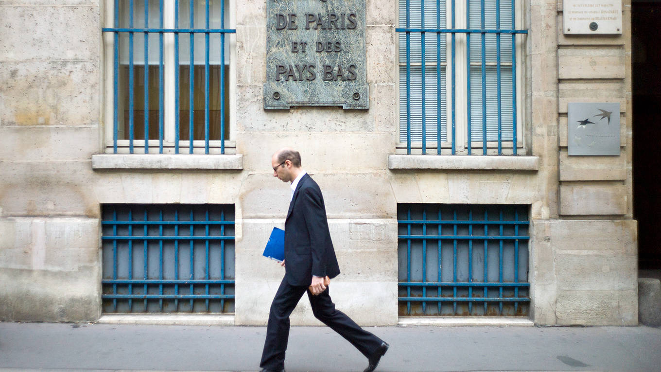 A man walks past BNP Paribas bank