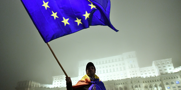 A man waves a European Union flag